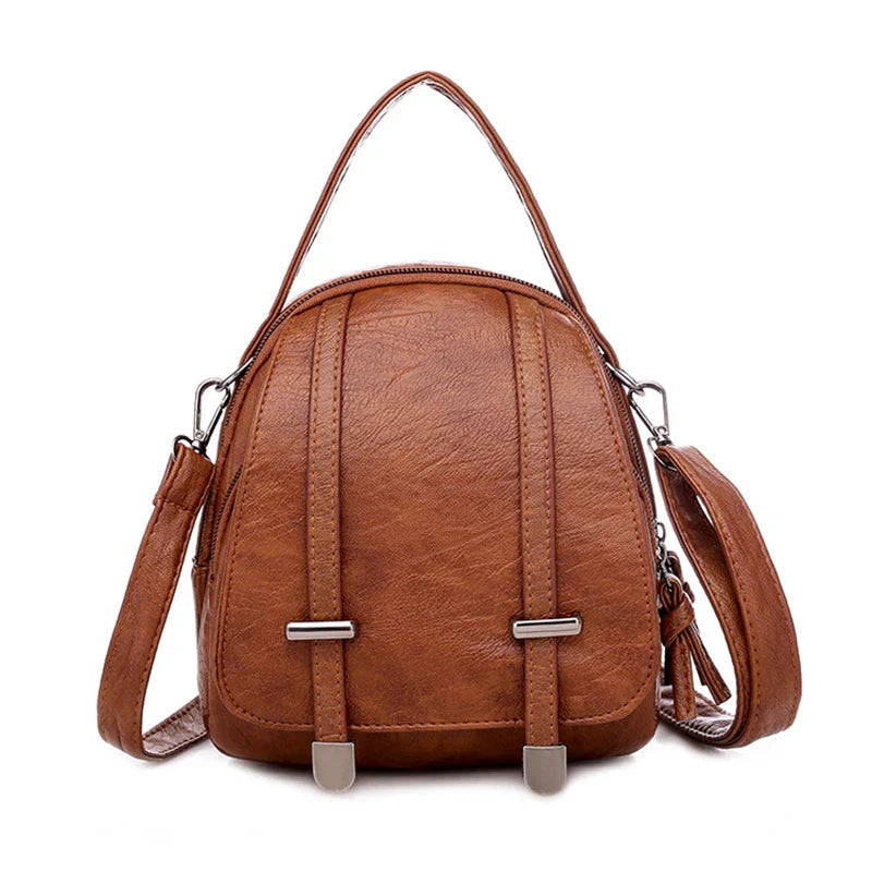 Zaino in pelle marrone elegante con manico superiore e tracolla regolabile, design moderno, ideale per moda donna, accessori di tendenza.