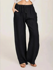Pantaloni larghi neri da donna, vita alta con laccio, tessuto leggero, stile casual, perfetti per l'estate.