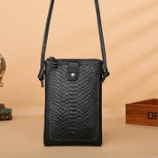Borsa a tracolla nera in pelle con texture rettile, design elegante e compatto, ideale per moda donna. Accessorio versatile per ogni occasione.