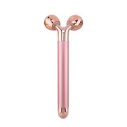 Rullo massaggiante viso rosa oro, doppia sfera, strumento bellezza anti-età, lifting, tonificante, cura pelle, accessorio skincare.