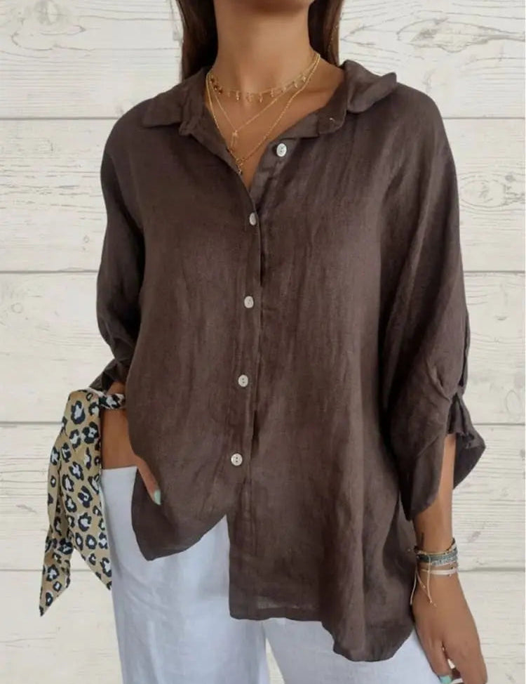 Camicia donna in lino marrone, maniche lunghe, bottoni frontali, abbinata a pantaloni bianchi. Stile casual elegante, moda femminile.