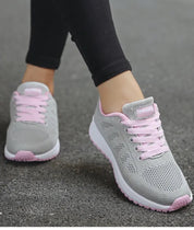 Scarpe da corsa donna grigie e rosa, design traspirante, suola antiscivolo, ideali per jogging e fitness. Comfort e stile sportivo.