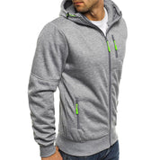 Felpa con cappuccio grigia da uomo, zip verde, tasche laterali, stile casual, ideale per sport e tempo libero. Materiale morbido e confortevole.