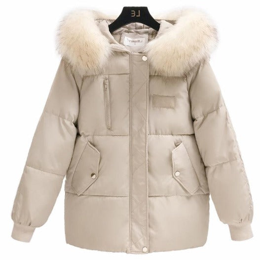 Giacca invernale beige con cappuccio in pelliccia sintetica, tasche frontali e chiusura a zip. Elegante e calda, ideale per la stagione fredda.