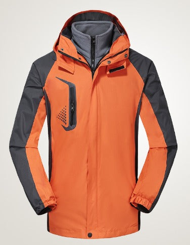 Giacca da sci arancione e grigia, impermeabile, con cappuccio e tasca frontale, ideale per sport invernali. Design moderno e funzionale.