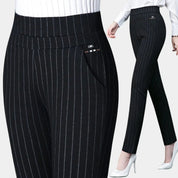 Pantaloni a righe nere da donna, eleganti e aderenti, con tasche laterali. Ideali per ufficio o eventi formali. Abbigliamento femminile moda.