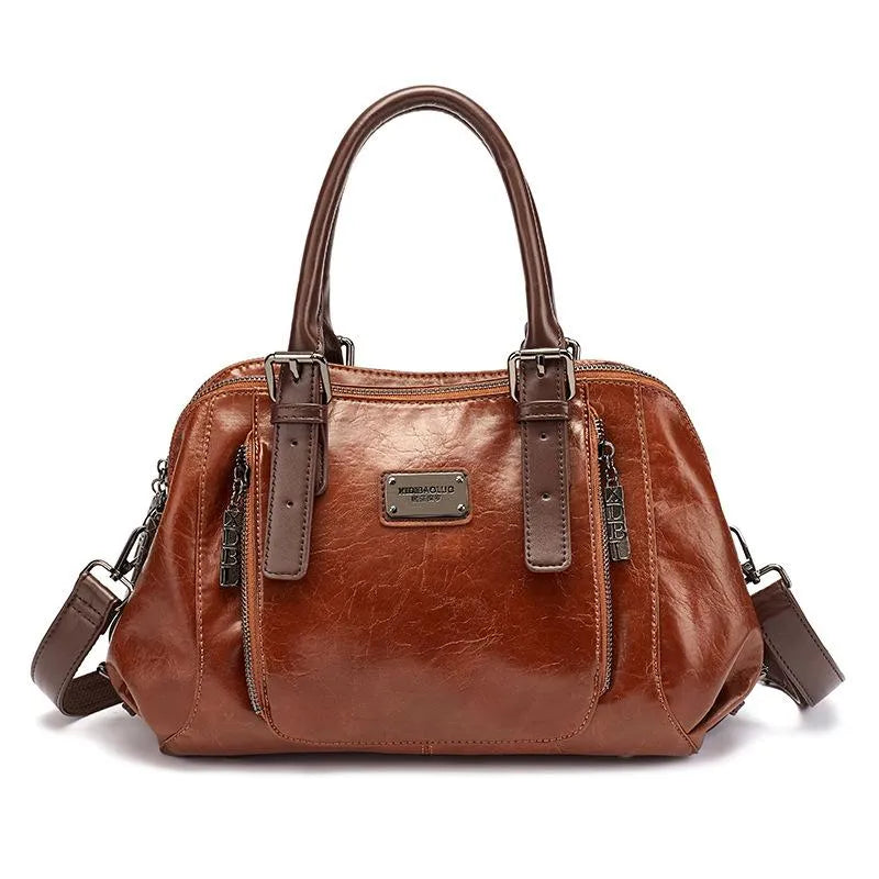 Borsa a mano in pelle marrone, design elegante con doppio manico, cerniere frontali e tracolla regolabile. Accessorio moda donna di tendenza.