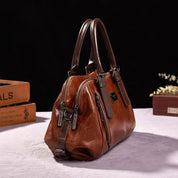 Borsa a mano in pelle marrone con doppia cerniera e manici robusti, design elegante, ideale per moda donna, accessorio di lusso.