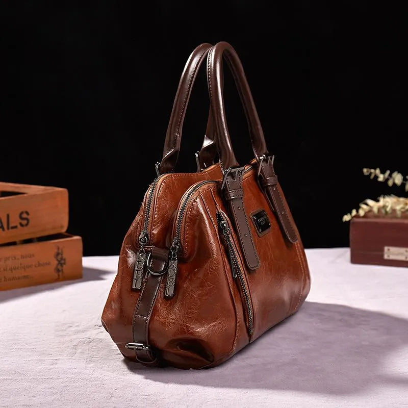 Borsa a mano in pelle marrone con doppia cerniera e manici robusti, design elegante, ideale per moda donna, accessorio di lusso.