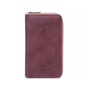 Portafoglio da viaggio in pelle rosa con cerniera, design per passaporto, logo aereo inciso, ideale per organizzare documenti e carte.