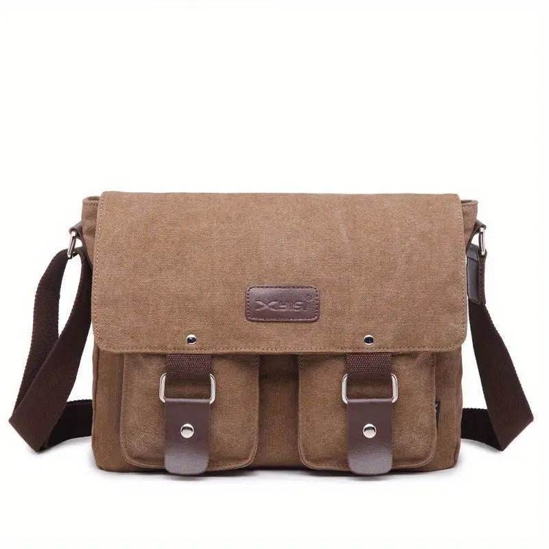 Borsa a tracolla in tela marrone con doppia fibbia, tasche frontali e tracolla regolabile. Design casual, ideale per uomo e donna.