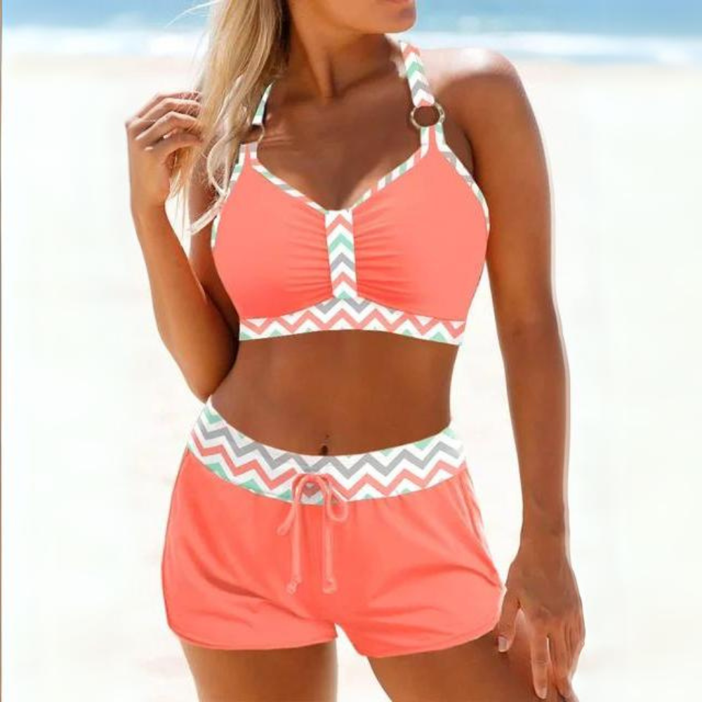 Costume da bagno donna arancione, top con spalline e pantaloncini a vita alta, motivo a zigzag, ideale per spiaggia e nuoto estivo.