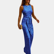 Abito lungo blu brillante senza maniche, donna elegante con pochette dorata. Vestito da sera glamour, moda femminile, abbigliamento formale.