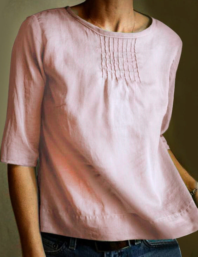 Blusa donna rosa in lino, maniche a tre quarti, scollo rotondo, dettagli pieghettati sul petto. Elegante e casual, perfetta per ogni occasione.