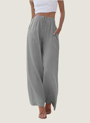 Pantaloni palazzo grigi da donna, vita alta con coulisse, tasche laterali, tessuto leggero. Ideali per look casual estivi.
