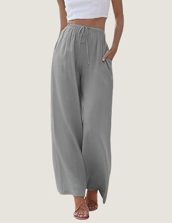 Pantaloni palazzo grigi da donna, vita alta con coulisse, tasche laterali, tessuto leggero. Ideali per look casual estivi.
