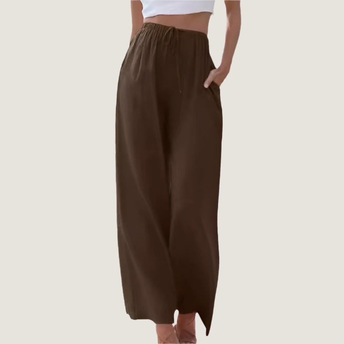 Pantaloni larghi marroni da donna, vita alta con elastico, tasche laterali, tessuto leggero. Ideali per look casual e comodi.