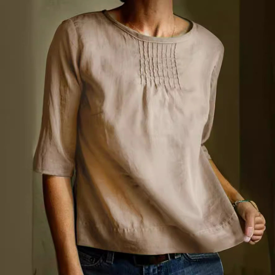Blusa donna beige in cotone, maniche a tre quarti, scollo rotondo, dettagli plissettati, stile casual elegante, perfetta per ogni occasione.