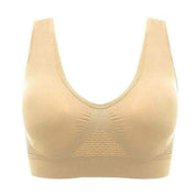 Reggiseno sportivo senza cuciture beige, design confortevole, supporto medio, tessuto traspirante, ideale per attività sportive e quotidiane.
