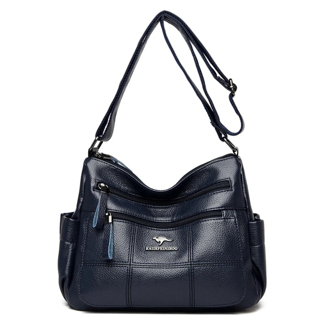 Borsa a tracolla in pelle blu scuro con tasche multiple e cerniere, design elegante e funzionale, ideale per donna, marchio visibile.