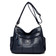 Borsa a tracolla in pelle blu scuro con tasche multiple e cerniere, design elegante e funzionale, ideale per donna, marchio visibile.
