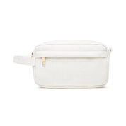 Astuccio da toilette bianco in tessuto a coste, con cerniera dorata e manico laterale. Elegante e pratico per viaggi e organizzazione bagno.