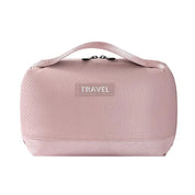 Borsa da viaggio rosa con manico, design compatto e chiusura a zip. Ideale per organizzare accessori e cosmetici. Perfetta per viaggi.