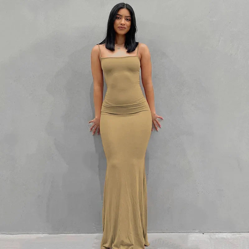 Abito lungo beige aderente da donna, senza maniche, elegante e moderno, perfetto per eventi serali o cerimonie.