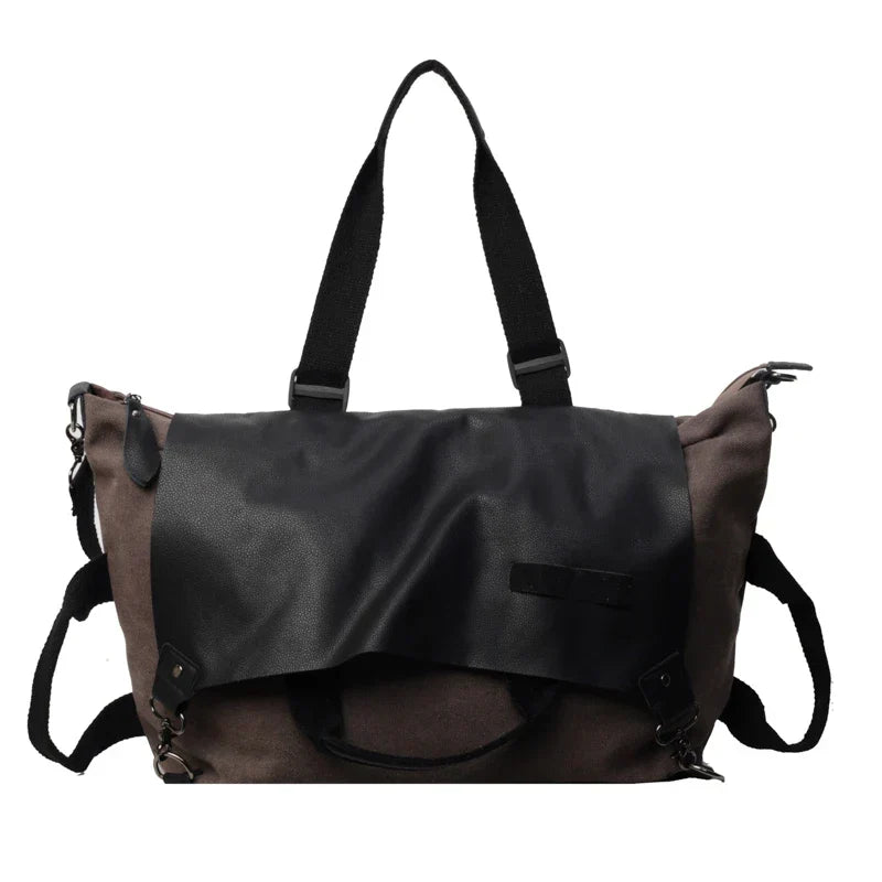 Borsa a tracolla in pelle nera e tessuto marrone, design moderno, manici robusti, ideale per lavoro e viaggio. Accessorio moda unisex.