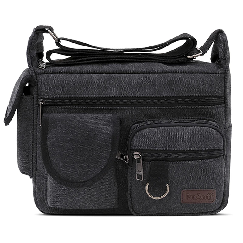 Borsa a tracolla nera in tela con tasche multiple e cerniere, design unisex, ideale per viaggi e uso quotidiano. Accessorio moda pratico e resistente.