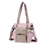 Borsa a tracolla rosa con tasche multiple, design moderno, manici lunghi, ideale per donna, moda casual, accessorio versatile e funzionale.