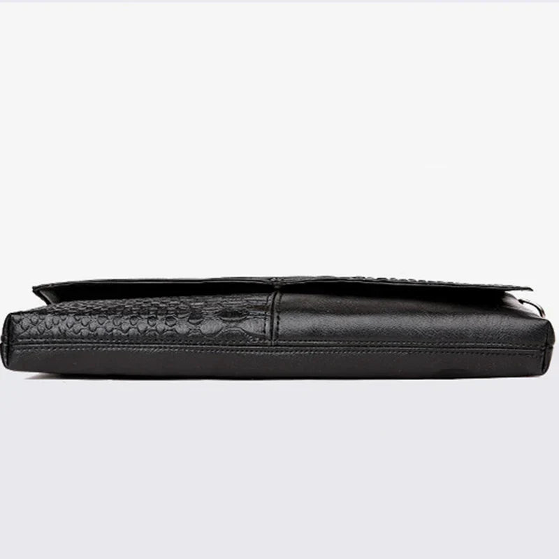 Elegante borsa a tracolla in pelle nera con texture a coccodrillo, design sottile e moderno, ideale per uomo d'affari. Accessorio di lusso.