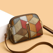 Borsa a tracolla donna in pelle patchwork multicolore, design geometrico, chiusura zip, elegante e moderna, perfetta per moda autunno inverno.