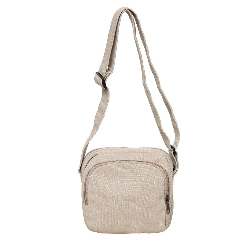 Borsa a tracolla beige in tessuto, design compatto con cerniera frontale, ideale per uso quotidiano. Accessorio moda pratico e versatile.