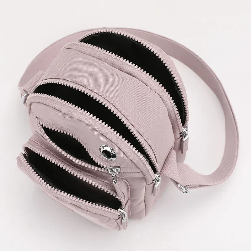Zaino compatto rosa con tre scomparti con cerniera, design moderno e funzionale, ideale per viaggi e uso quotidiano. Accessorio moda donna.
