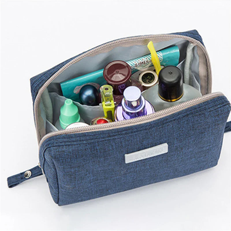 Astuccio da viaggio blu aperto con prodotti cosmetici e da toilette, ideale per organizzare articoli personali. Accessorio pratico e compatto.
