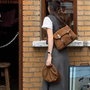 Donna con zaino in pelle marrone e cappello abbinato, davanti a un edificio in mattoni. Moda autunnale, accessori eleganti, stile casual.