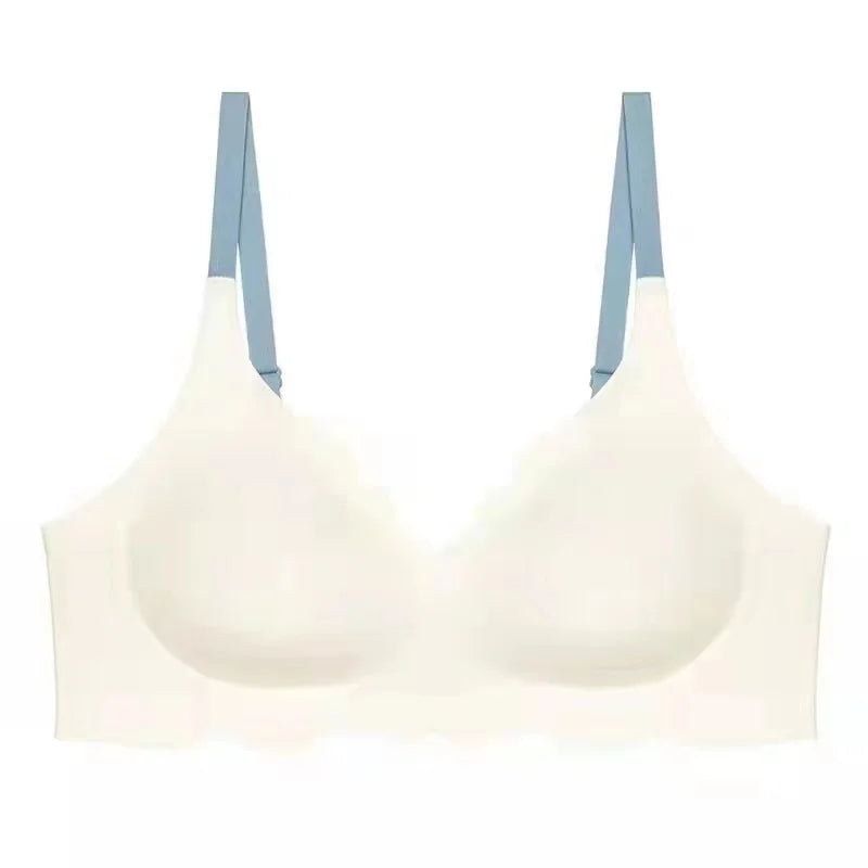 Reggiseno bianco senza cuciture con spalline blu, design confortevole e supporto leggero, ideale per uso quotidiano. Intimo donna elegante.