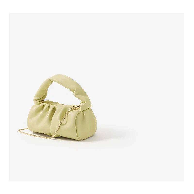 Borsa a mano verde chiaro in pelle sintetica con manico imbottito e tracolla dorata. Design moderno, accessorio moda elegante e versatile.