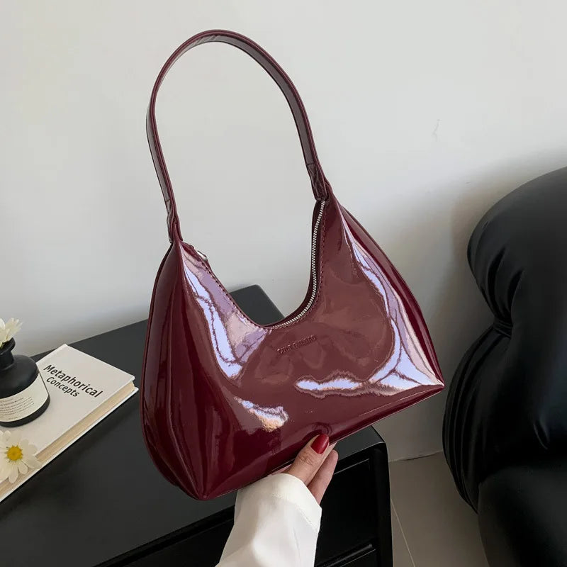 Borsa a spalla in pelle verniciata bordeaux, design elegante e moderno, perfetta per moda donna, accessorio chic per ogni occasione.