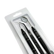 Set di strumenti dentali in acciaio inox, specchietto, sonda e scaler, confezione blister, strumenti per igiene orale professionale.