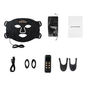 Maschera facciale LED nera con accessori: telecomando, cavo USB, custodia e manuale. Trattamento viso, cura della pelle, tecnologia bellezza.