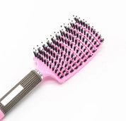 Spazzola per capelli rosa con setole nere, manico ergonomico antiscivolo. Accessorio styling capelli, ideale per districare e lisciare.
