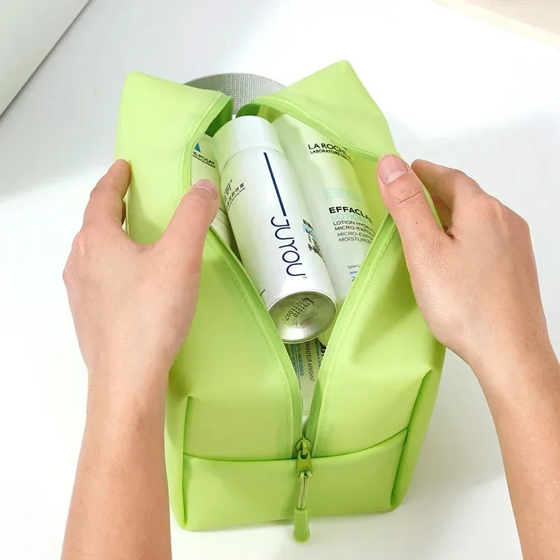 Mani che aprono una trousse verde con prodotti skincare, tra cui crema idratante e lozione. Accessori bellezza, cura della pelle, cosmetici.