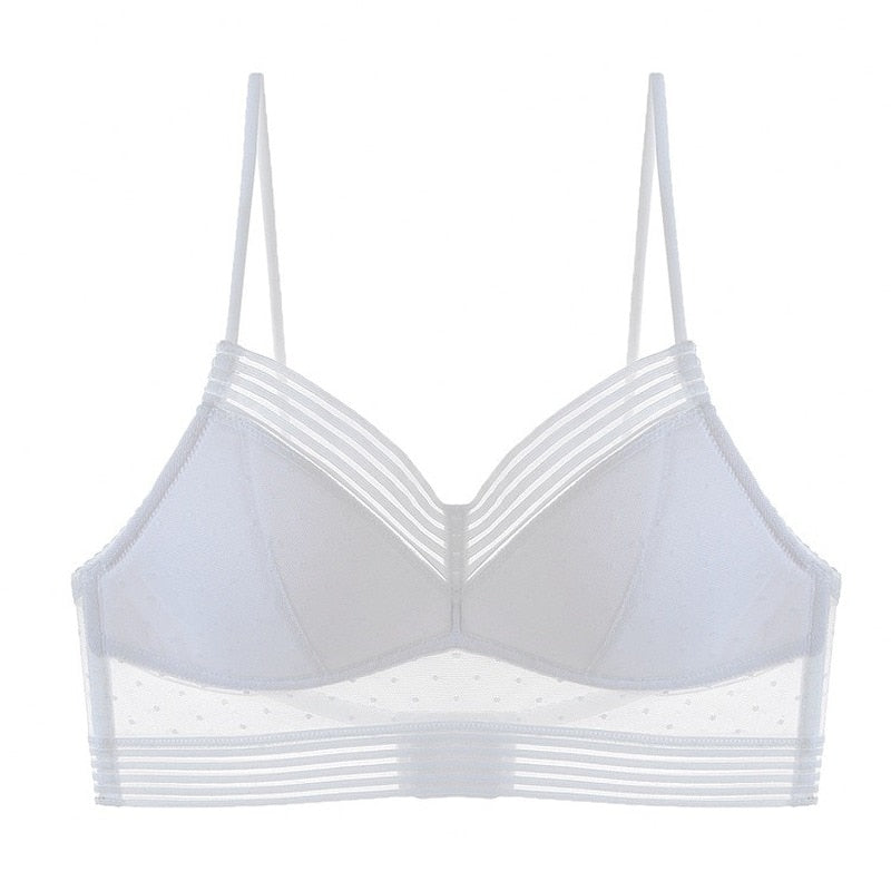Reggiseno bianco trasparente con spalline sottili, design a righe e dettagli a pois. Intimo femminile elegante e moderno.