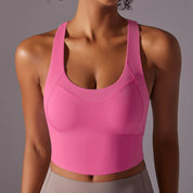 Top sportivo donna rosa, design senza maniche, tessuto traspirante, ideale per yoga e fitness. Comfort e stile per allenamenti intensi.