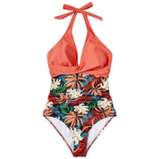 Costume intero donna tropicale, scollo all'americana, stampa foglie colorate, design elegante, perfetto per spiaggia e piscina.
