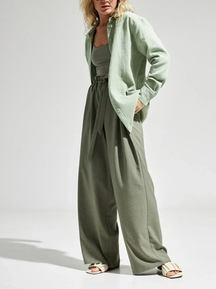 Donna in abbigliamento casual verde: camicia leggera, top e pantaloni larghi. Moda estiva, stile rilassato, tendenze 2023.
