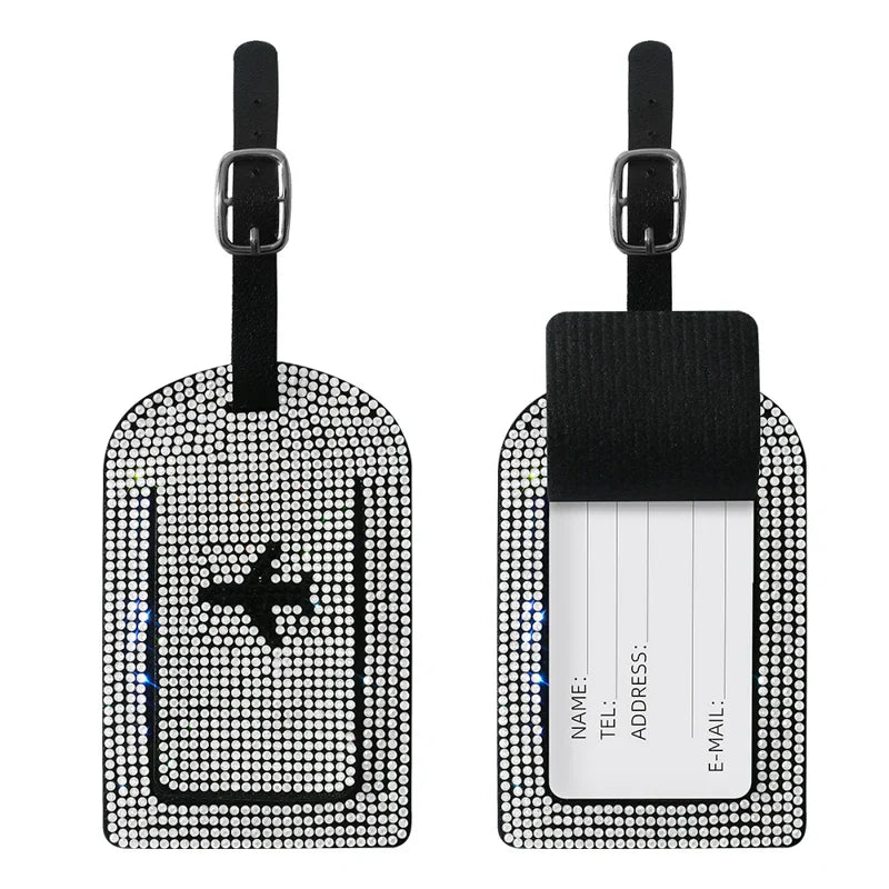 Etichette bagaglio con strass, design aereo, nero e argento, con fibbia regolabile. Accessorio viaggio elegante e funzionale per valigie.