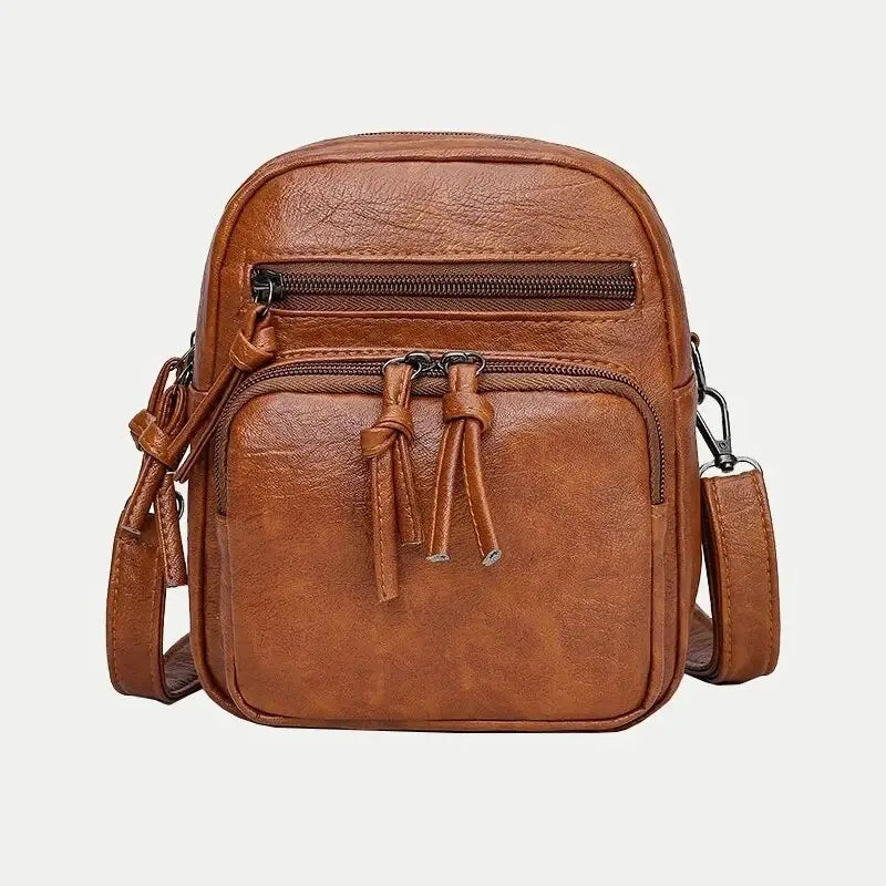 Borsa a tracolla in pelle marrone, design compatto con doppia cerniera e tasca frontale. Accessorio moda uomo/donna, stile casual ed elegante.